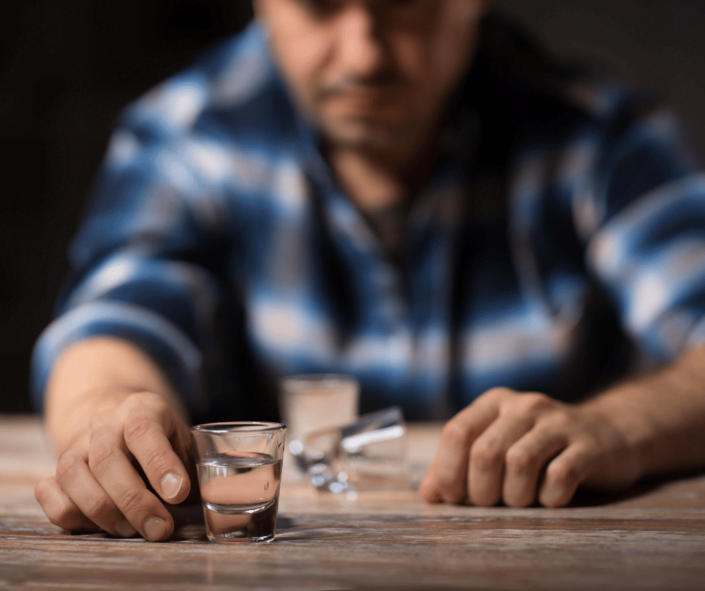 Alcohol Craving - Man with shots of alcohol 